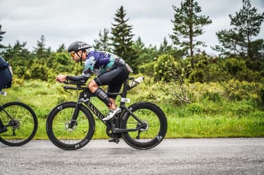 Christian Plesca in the aero position on the time trial bike on the bike course.