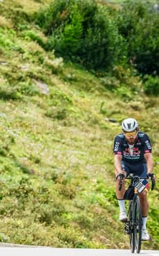 Christian Plesca climbing a steep mountain road on the road bike.