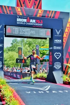 Christian Plesca running through the finish arch at the IRONMAN 70.3 World Championship.