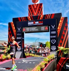 Christian Plesca crossing the finish line at the IRONMAN 70.3 World Championship.